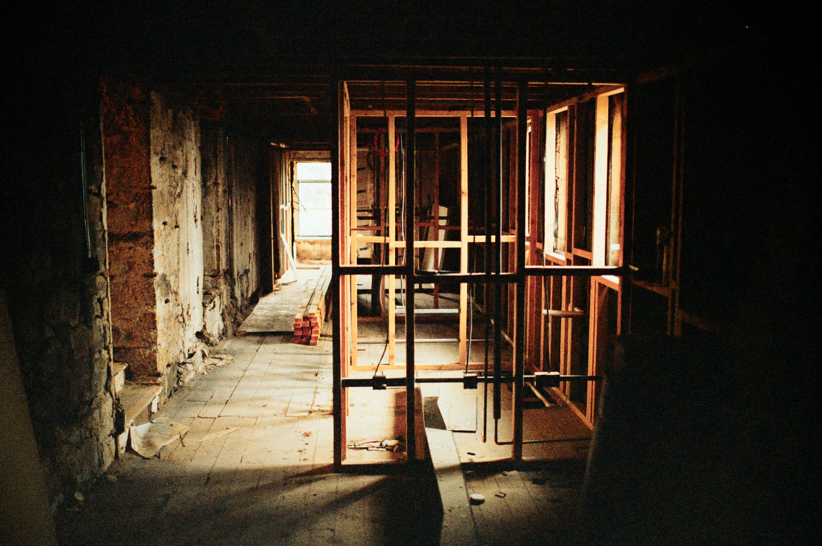 Interior demolition with wood stud partitions and exposed stone